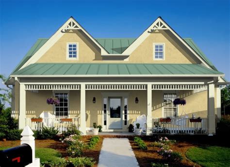 brick house with green metal rood and yellow door|house with green roof colors.